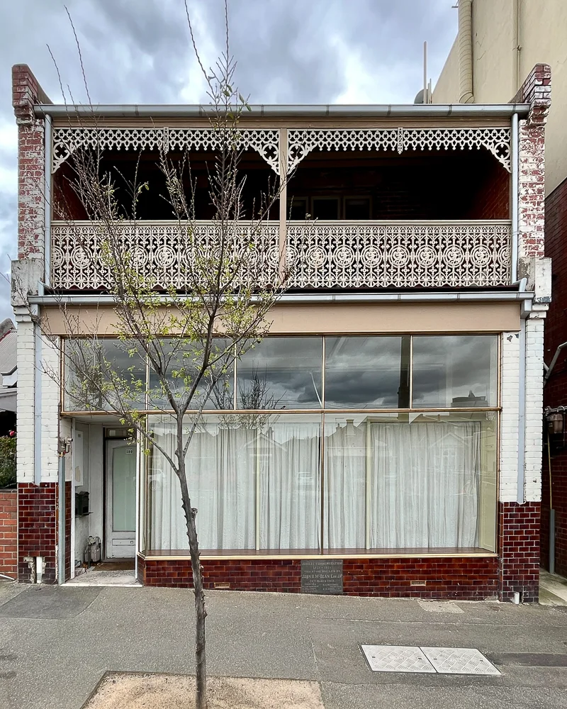 Full facade showing the copper-framed shopfront window assembly
